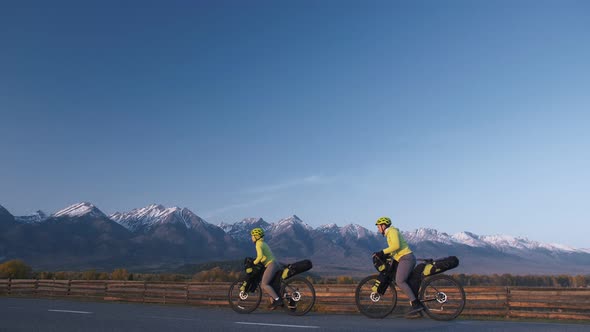 The Man and Woman Travel on Mixed Terrain Cycle Touring with Bikepacking. The Love Couple Journey