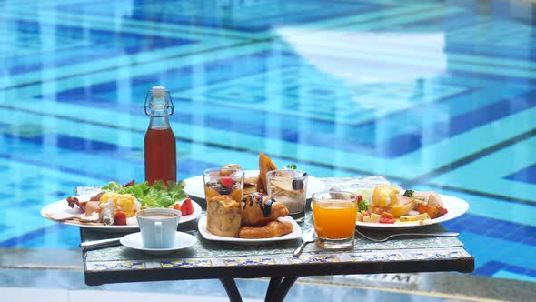 Breakfast Served on Terrace in Outdoors Poolside Restaurant at Luxury Hotel or Resort