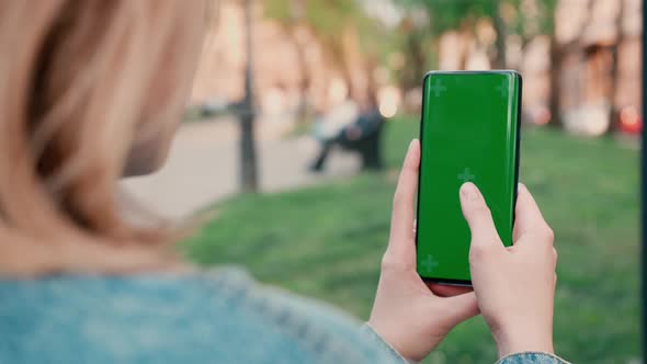 Lviv Ukraine May 6 2022 Close Up of a Woman's Hand Scrolling a Mobile Telephone with a Vertical