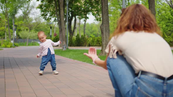 Baby Learning to Walk Toddler Taking First Steps with Mother Helping Infant Teaching Child at