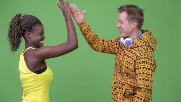 Young Multi-ethnic Couple Giving High-five Together