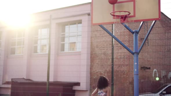 Young Woman Playing Basketball