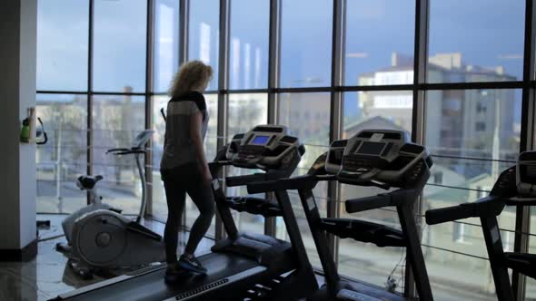 Silhouette of a Girl Running on a Treadmill