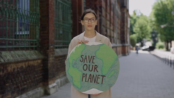 Single Female Eco Activist Standing and Holding Banner Save Our Planet on Street