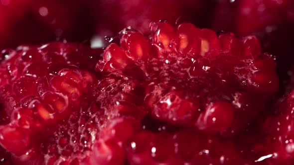 Super Slow Motion Macro Shot of Water Droplets Falling on Fresh Raspberries at 1000Fps.