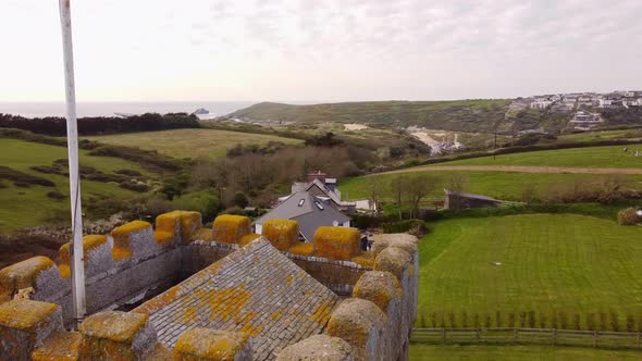 Aerial Crantock Village Church spire revealing Crantock Beach in Cornwall