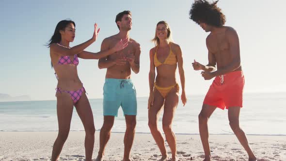 Friends dancing at beach