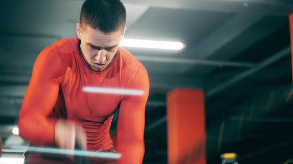 A Man Is Doing an Exercise with Ropes During Workout