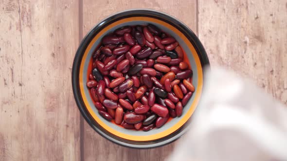 Pouring Grains Red Bean in a Bowl on Table