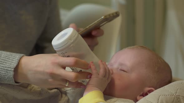 Mother Feeds Baby Phone