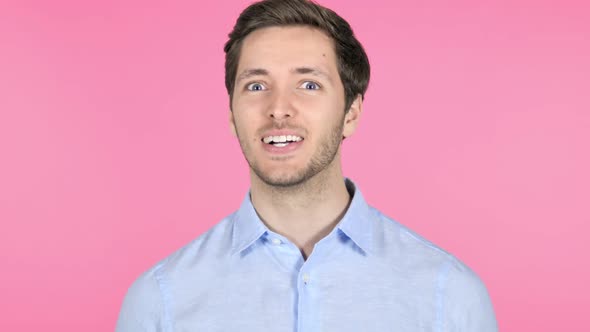 Yes Admiring Young Man on Pink Background