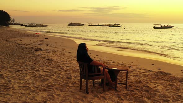 Beautiful beauty model on vacation spending quality time at the beach on paradise white sand and blu