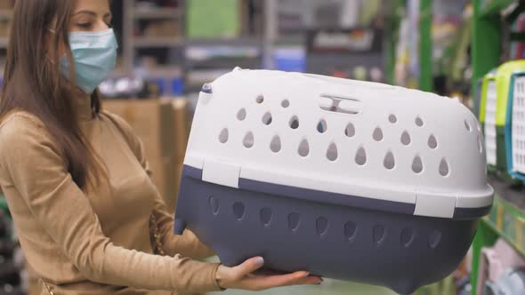 Assistant Takes Grey White Animal Carrier From Shelf