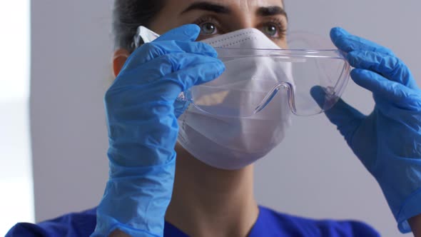 Female Doctor or Nurse in Goggles and Face Mask