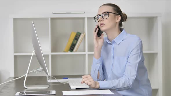 Young Casual Girl Talking on Phone and Using Computer