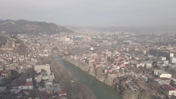 Aerial view of Metekhi church in old Tbilisi located on cliff near river Kura. Georgia 2021 winter