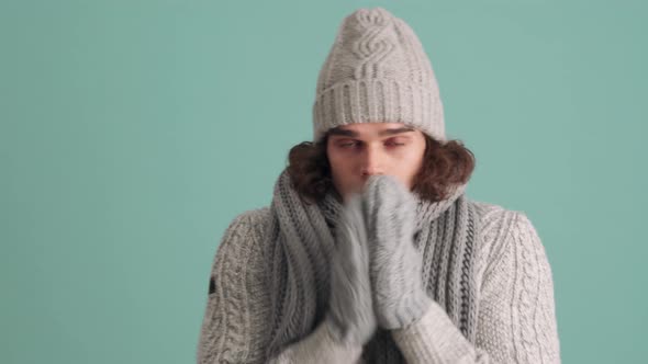 Handsome man in hat is cold