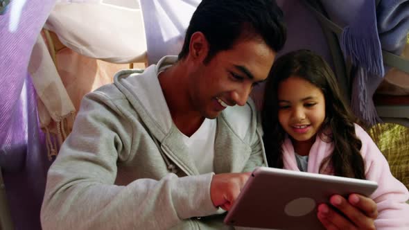 Father and daughter using digital tablet