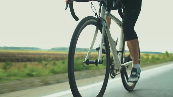 Female Triathlete Riding Sport Bike on Road