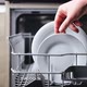 Female Hand Takes Washed Plate From the Basket of an Open Dishwasher Machine - VideoHive Item for Sale