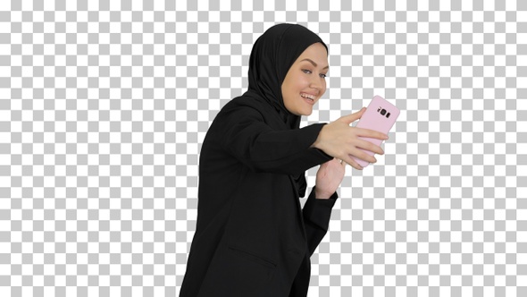 Smiling Arab woman in hijab taking selfie, Alpha Channel