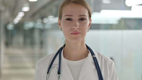 Portrait of Serious Female Doctor Looking at Camera 