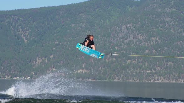 Young man wake boarding on a lake.