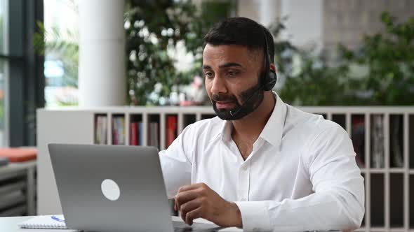 Sociable Attractive Smart Indian Entrepreneur Business Man Sales Manager Trader with Headphones Sit