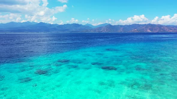 Natural fly over copy space shot of a white sand paradise beach and blue sea background in colorful 