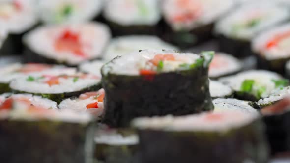 The Chef Lays Down Sets for Delivery Pieces of Sushi and Roll Made From Seafood with Asian