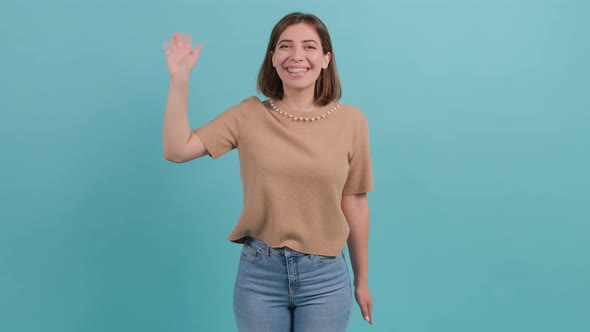 Friendly Beautiful Woman Saying Hi and Smiling Welcoming Friends with Hand