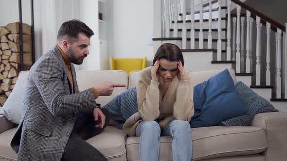 Bearded Man Arguing with His Silent Disappointing Girlfriend on the Couch