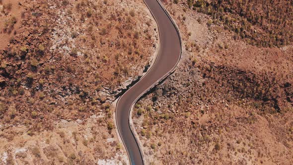 Aerial view of road between rocky mountains in Canary Island