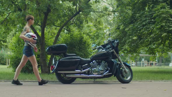 Stylish Female Biker with Helmet Ready for Ride