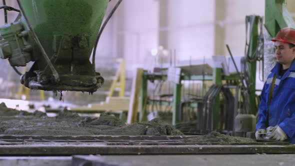 Manufacture worker controlling machinery at building factory