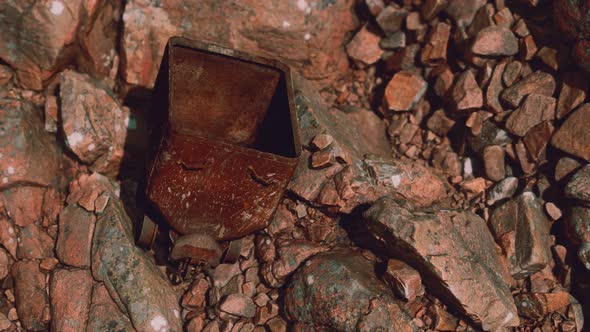 Abandoned Rusty Mine Cart on Rocks alt