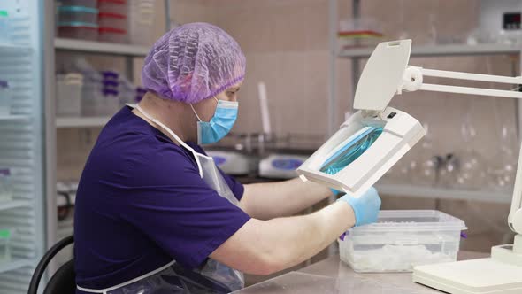 A Laboratory Worker Checks the Condition of the Samples Before Testing