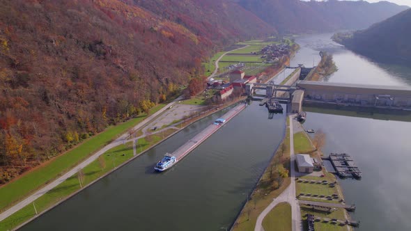 Cargo Pusher Transport Boat Traversing a Lock Moving Freight and Goods