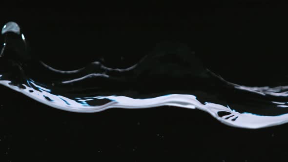Super Slowmotion Shot of Water Wave Against Black