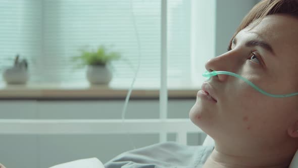 Female Patient with Nasal Cannula Lying on Hospital Bed