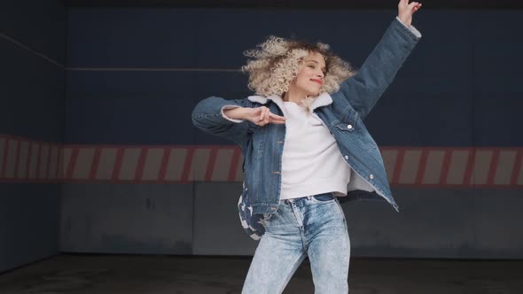 Concept of Fun and Good Mood. Charming Curly Girl Dancing Crazy Outdoors