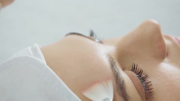 Beautician Applying Beauty Oil Mask on Face for Woman