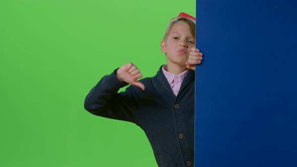 Child Boy in a Christmas Hat Appears From the Side of the Board Holding Her Hands in Front Then