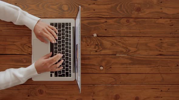 Female Hands Type Over Keyboard of Laptop