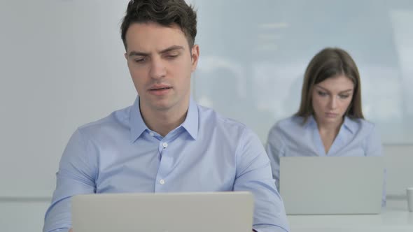 Tired Businessman Yawning at Work