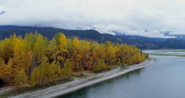 Scenic view of mountain ranges, autumn trees and lake 4k