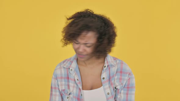 Disappointed Young African Woman Reacting Loss on Yellow Background