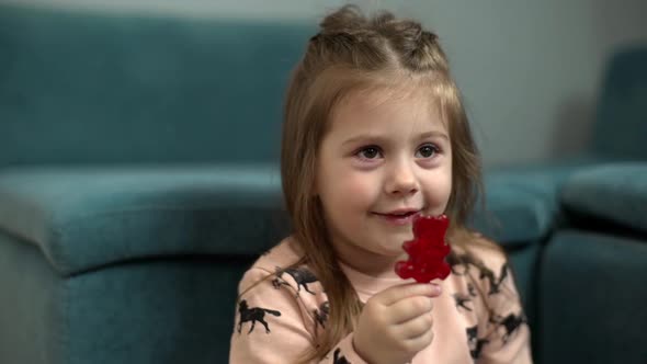 Portrait Closeup of Caucasian Kid with Red Lollipop in Mouth Enjoying Happy Carefree Childhood and