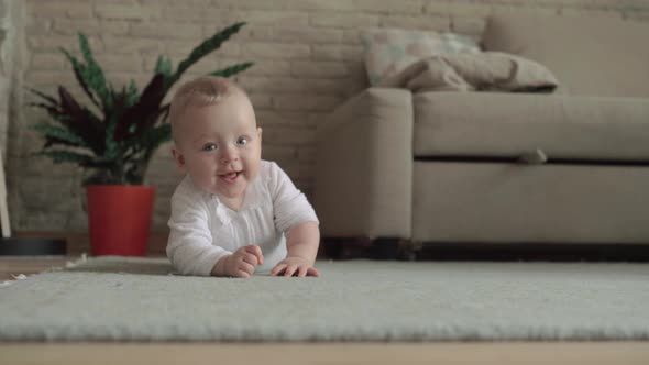 Lovely Eight Months Baby Girl on the Floor at Home