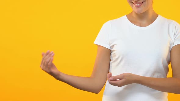 Lady Showing Empty Place for Advertisement or Text Isolated on Orange Background